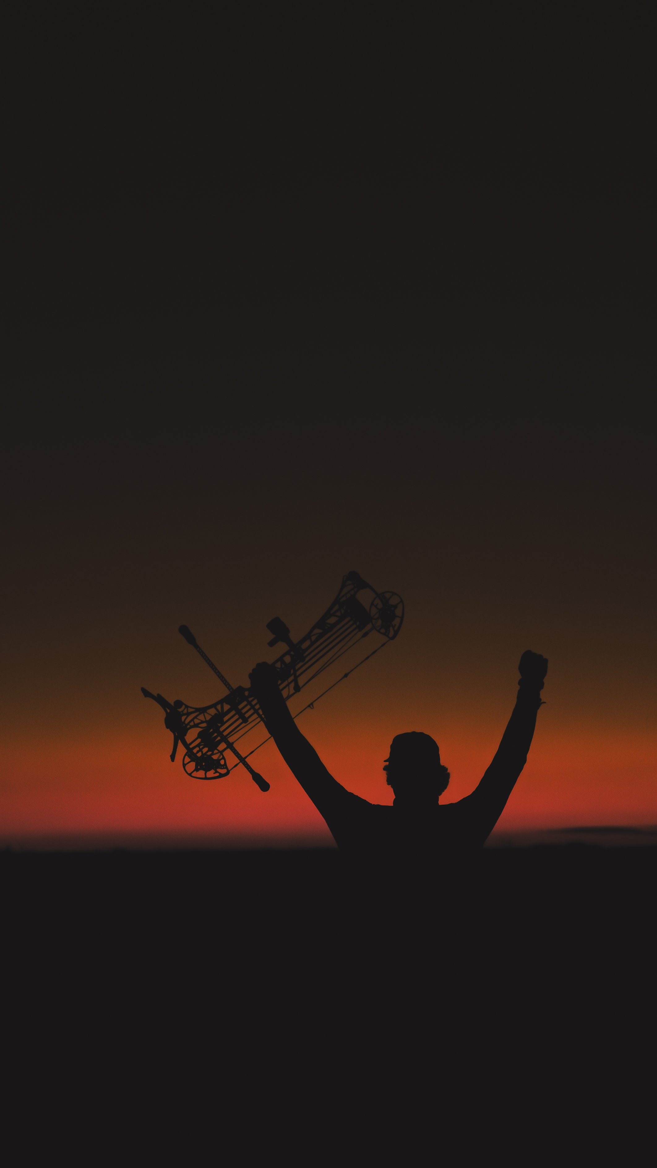 Bowhunter silhouette at sunset